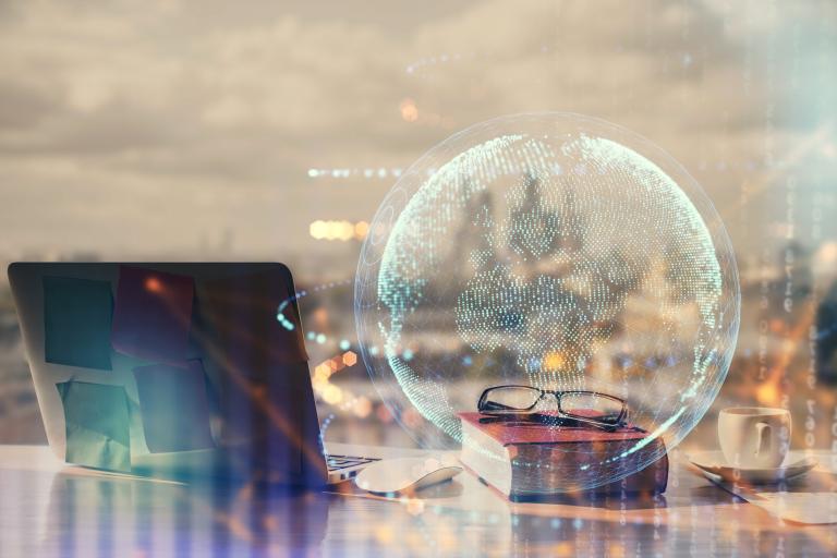 Layered image of a skyline, laptop and globe outline