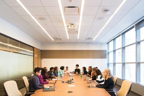 people in a board room sitting down