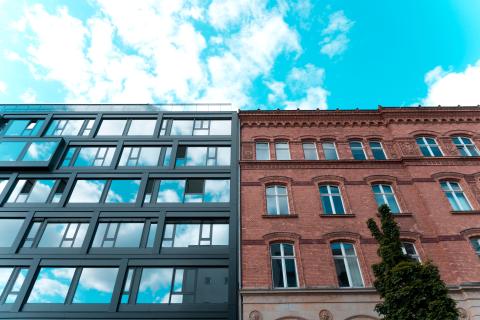 Two buildings next to each other, one old and one new