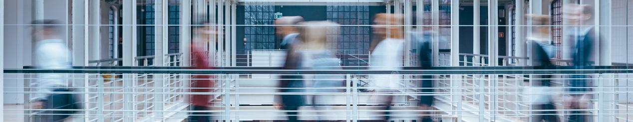 Blurred image of business people walking in an open indoor space